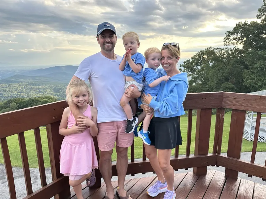 Alex Crutchfield with his wife Lindsay and their three children on a deck overlooking the Blue Ridge at sunset